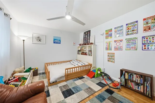 a bedroom with furniture and a book shelf