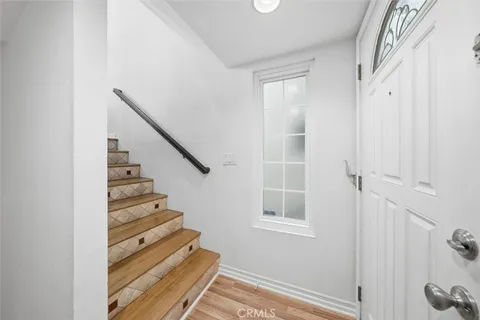 a view of entryway and hall with wooden floor