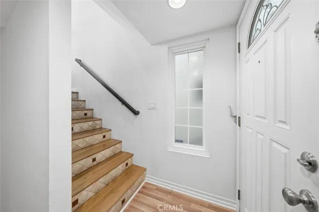 a view of entryway and hall with wooden floor