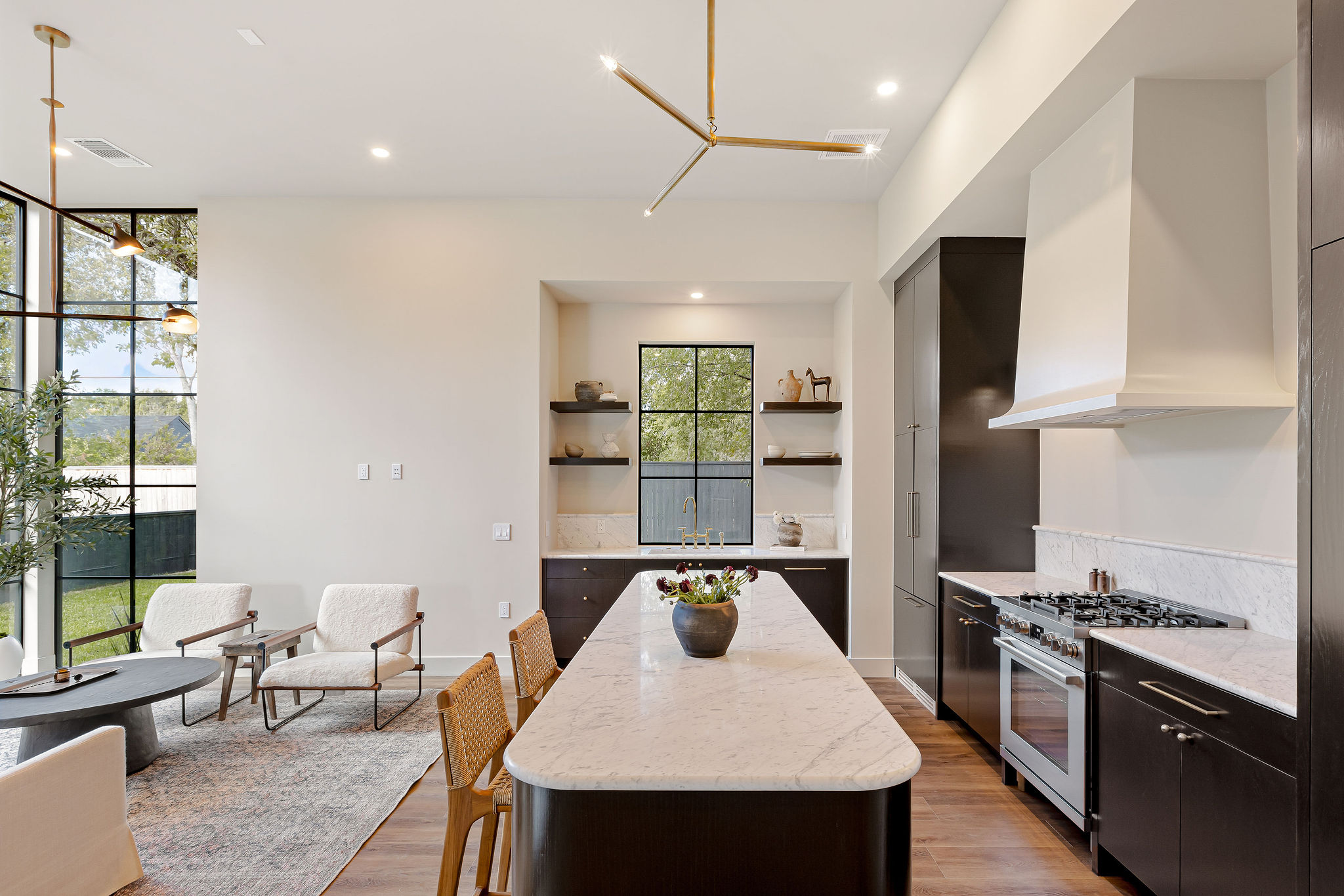 4412 Banister Lane, Unit 2 Austin, TX 78745 - Photo 12 of 29 a kitchen with a stove a refrigerator and a dining table with wooden floor