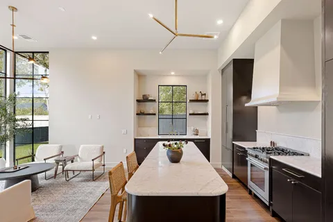 a kitchen with a stove a sink and a refrigerator