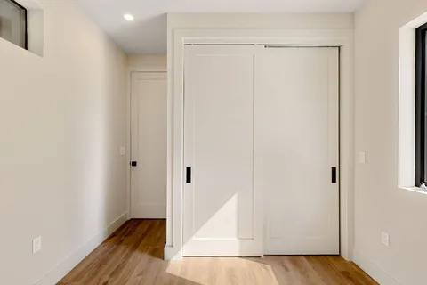 a view of hallway with wooden floor