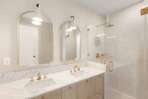 a bathroom with a sink double vanity and a mirror