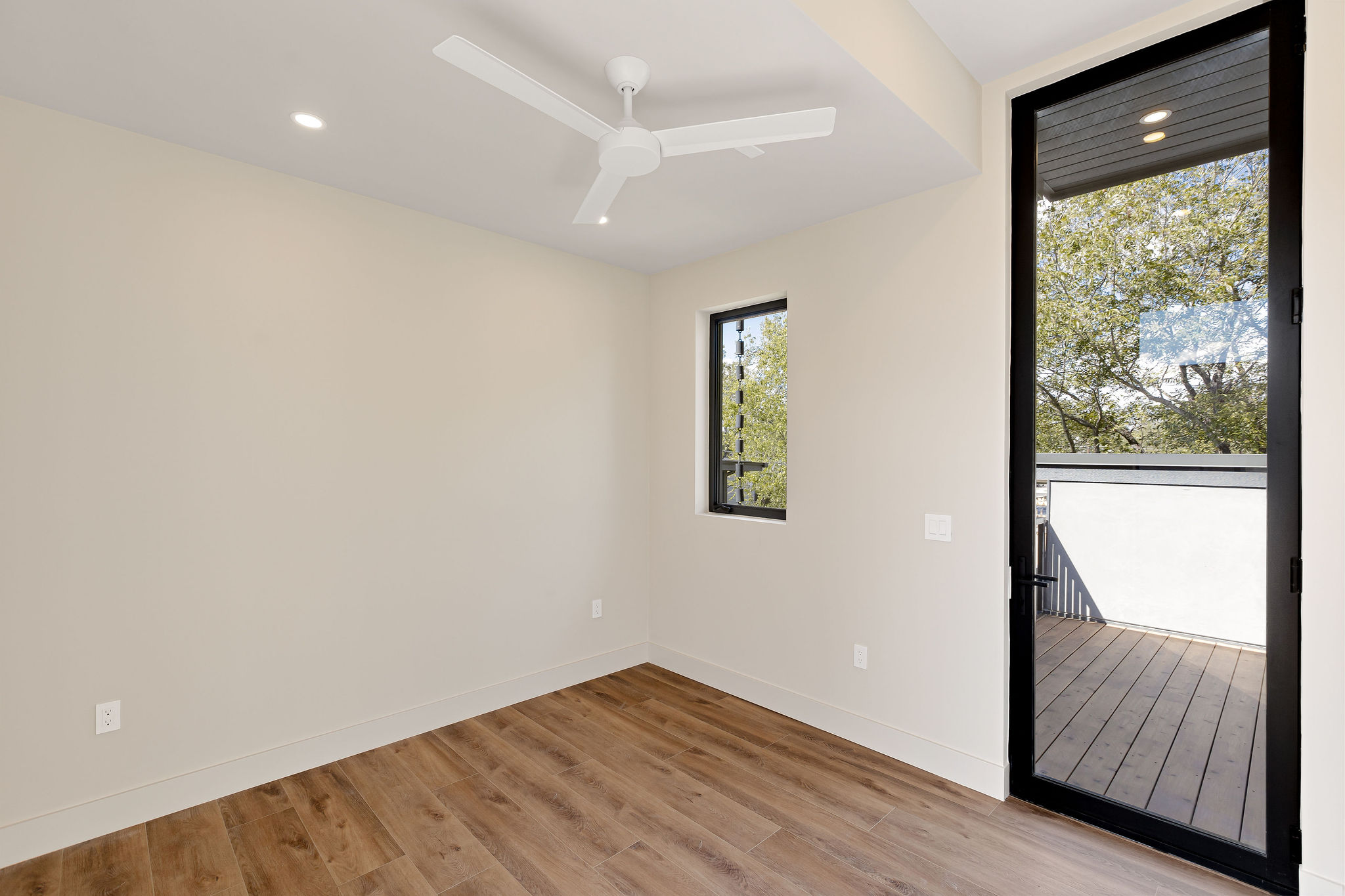4412 Banister Lane, Unit 2 Austin, TX 78745 - Photo 24 of 29 a view of hallway with a large window and wooden floor