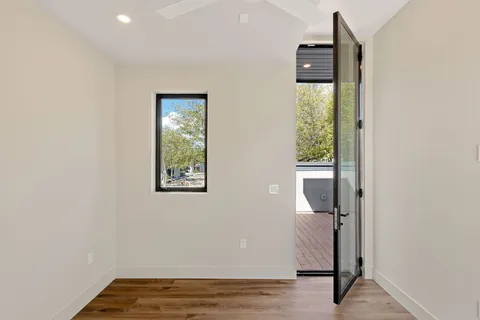 wooden floor in an empty room with a window