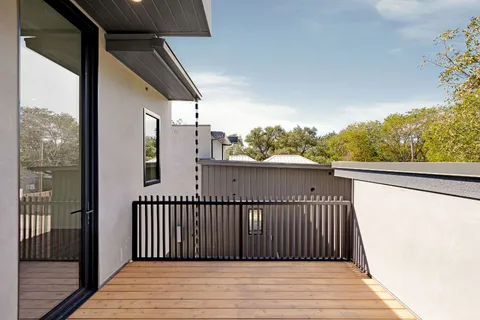 a view of a balcony with wooden floor