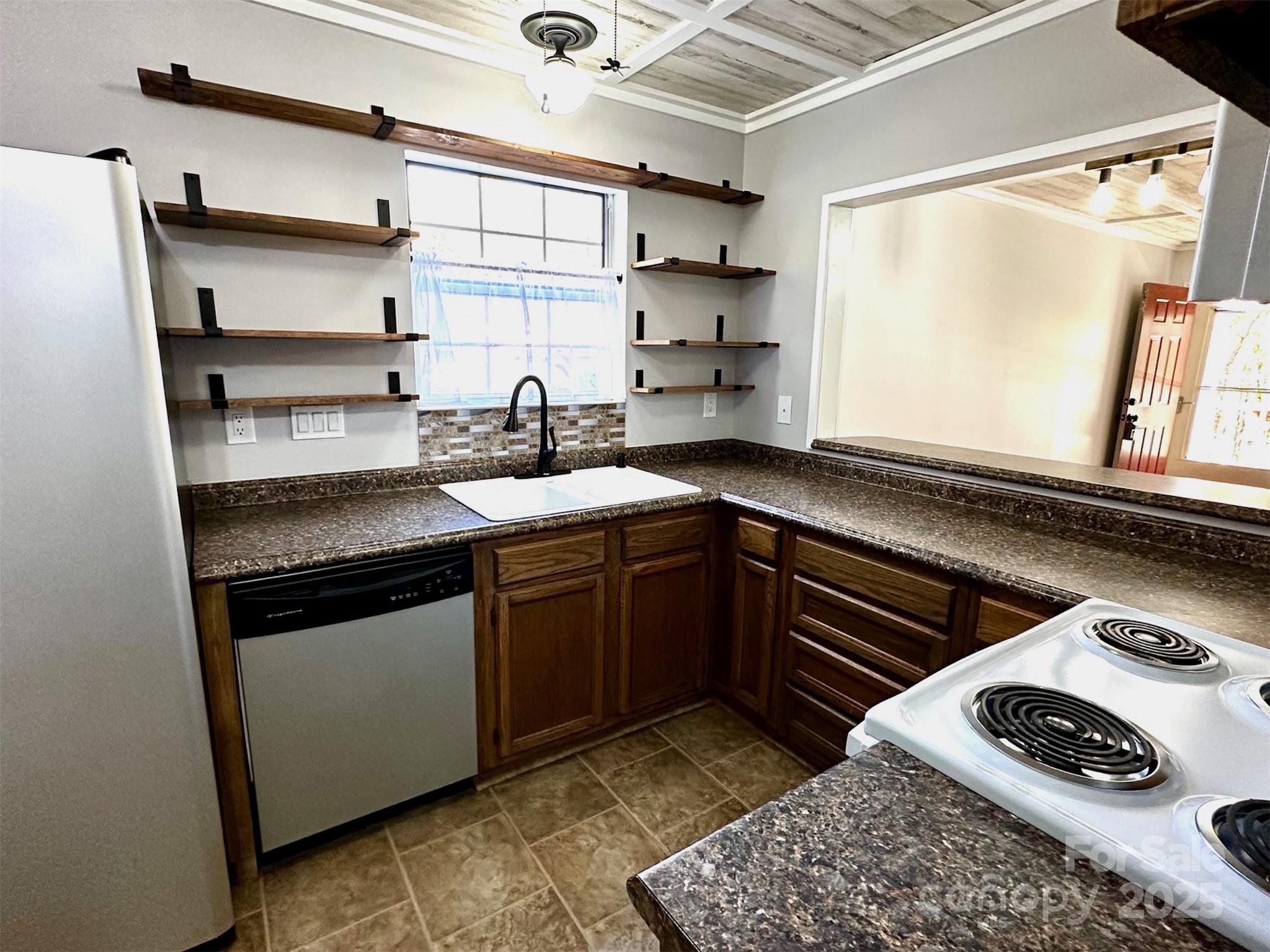 3 Rocking Porch Road Asheville, NC 28805 - Photo 14 of 25 a kitchen with stainless steel appliances granite countertop a sink stove and cabinets