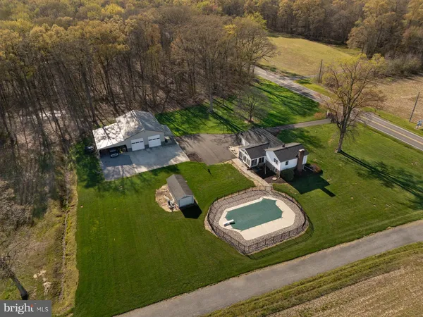 an aerial view of a house with garden space and street view