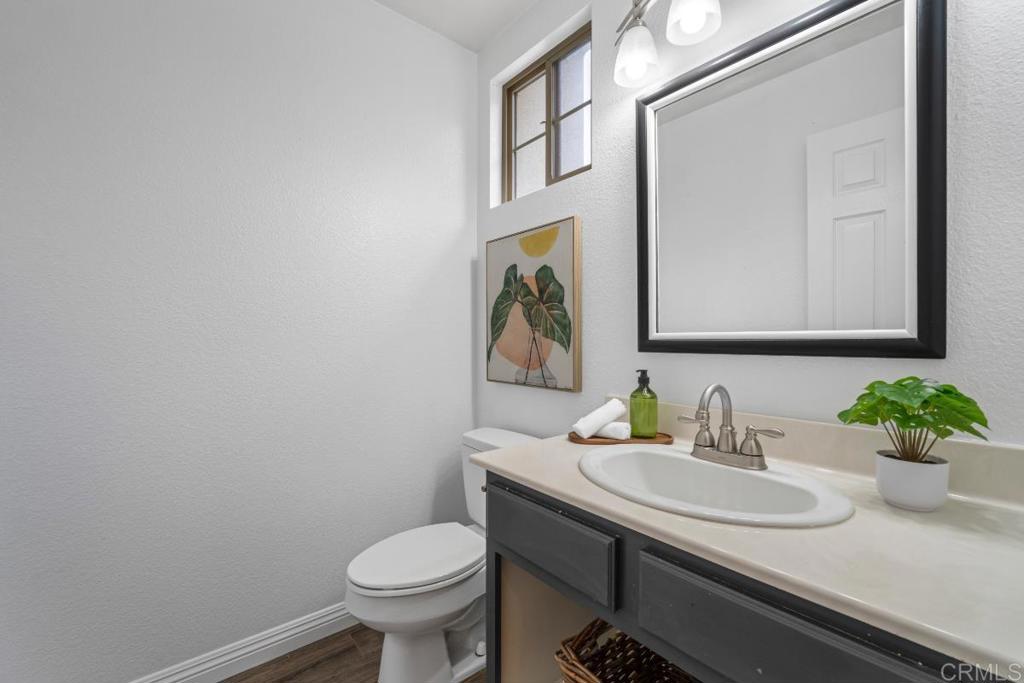 5511 Old Ranch Road, Unit 19 Oceanside, CA 92057 - Photo 11 of 32 a bathroom with a granite countertop sink and a mirror