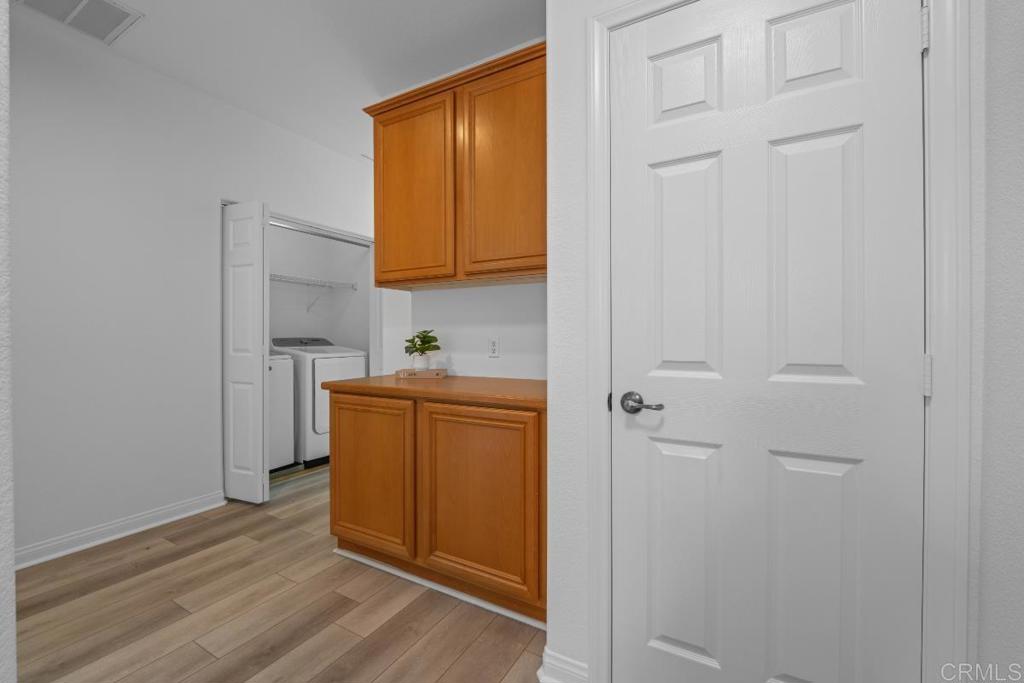 5511 Old Ranch Road, Unit 19 Oceanside, CA 92057 - Photo 13 of 32 a room with wooden floor and cabinets