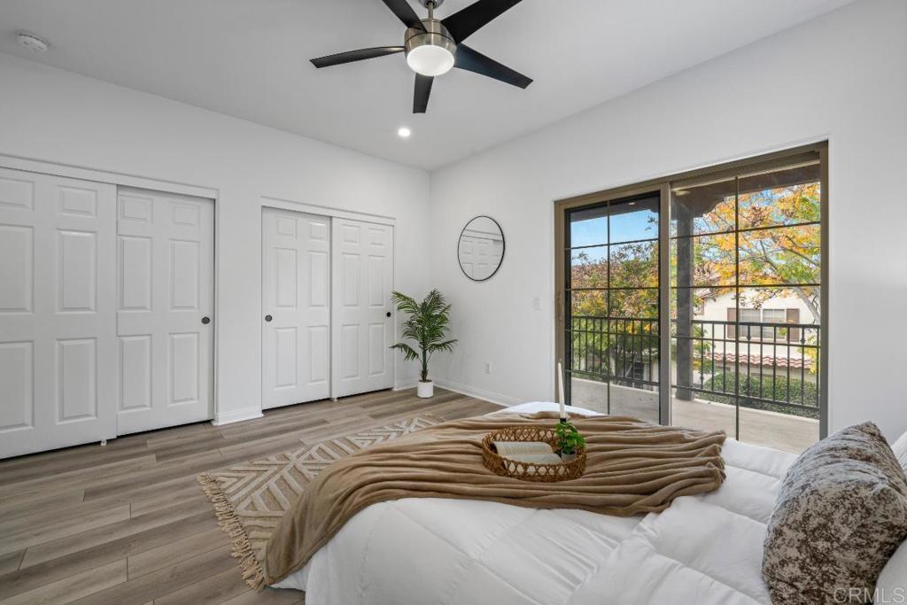 5511 Old Ranch Road, Unit 19 Oceanside, CA 92057 - Photo 16 of 32 a bedroom with a bed and a large window