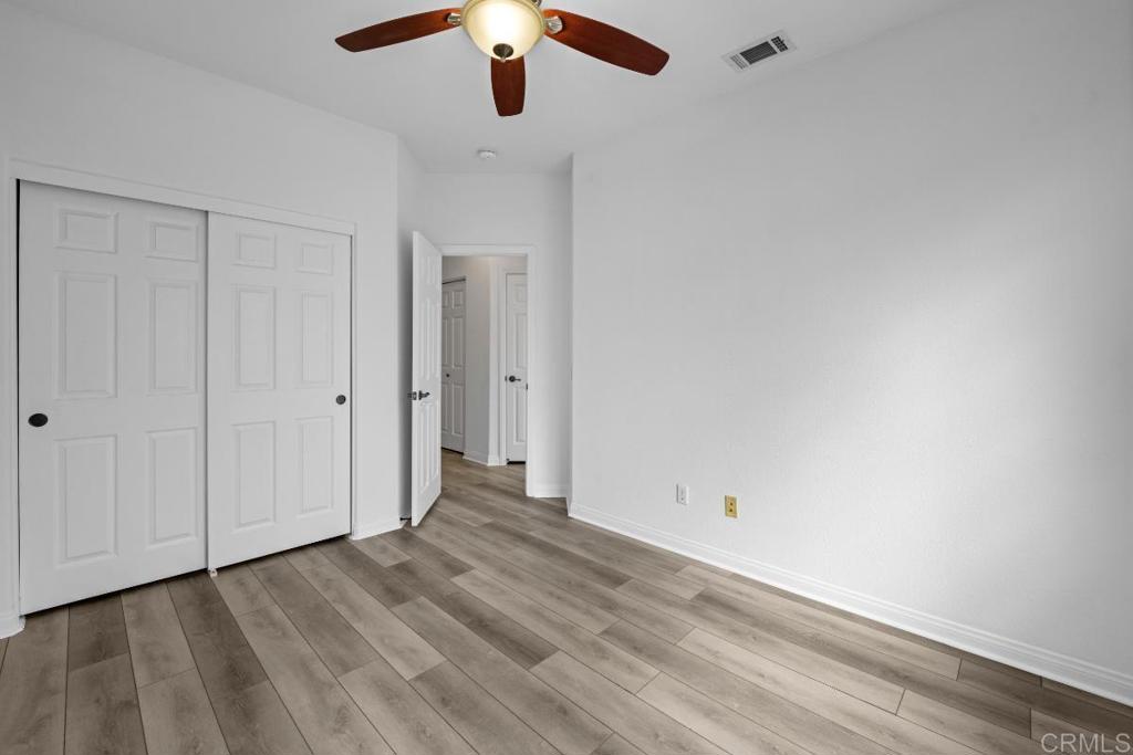 5511 Old Ranch Road, Unit 19 Oceanside, CA 92057 - Photo 19 of 32 an empty room with a hardwood