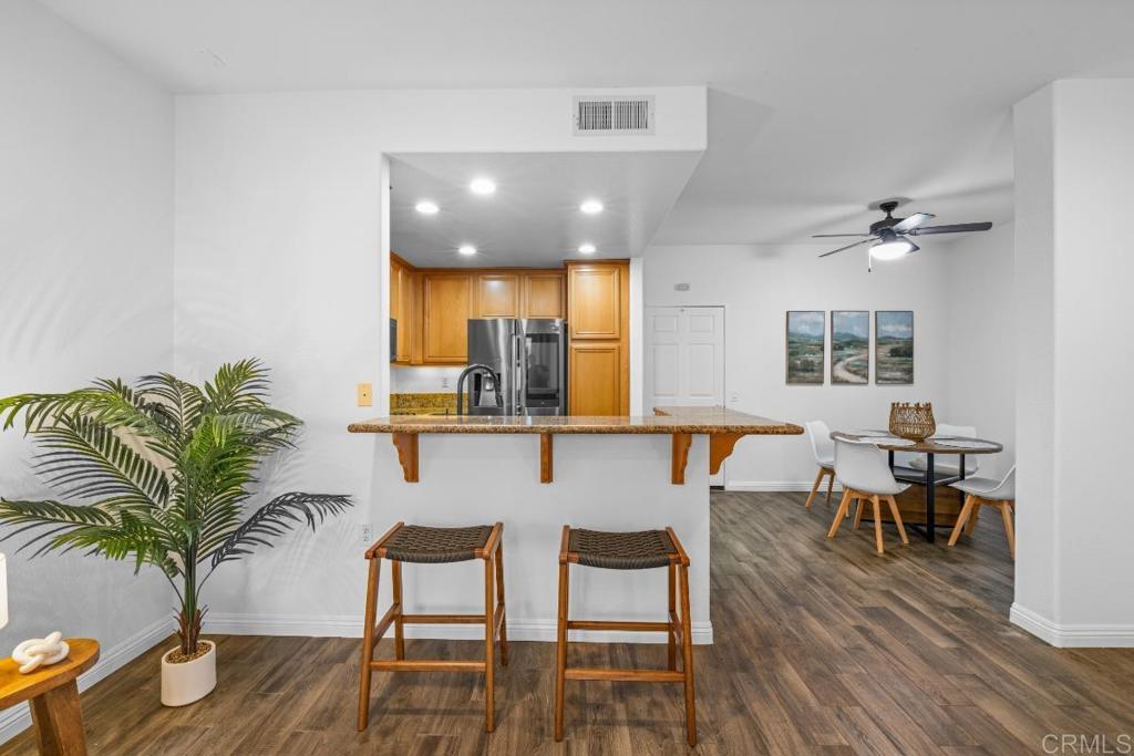 5511 Old Ranch Road, Unit 19 Oceanside, CA 92057 - Photo 7 of 32 a view of a dining room with furniture and wooden floor