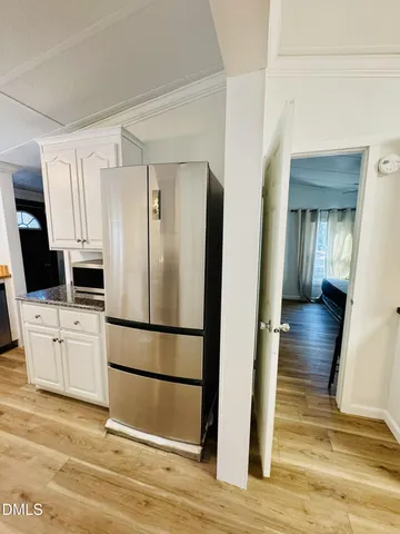 a kitchen with white cabinets and stainless steel appliances