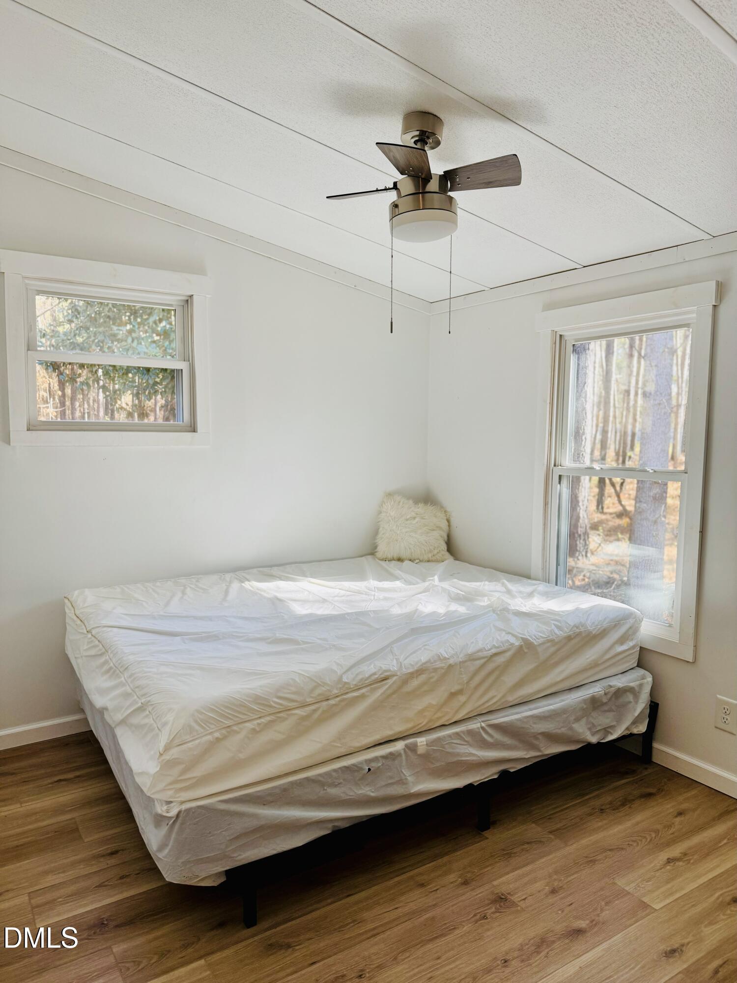3280 Lakebay Road Vass, NC 28394 - Photo 28 of 41 a bedroom with a bed and wooden floor