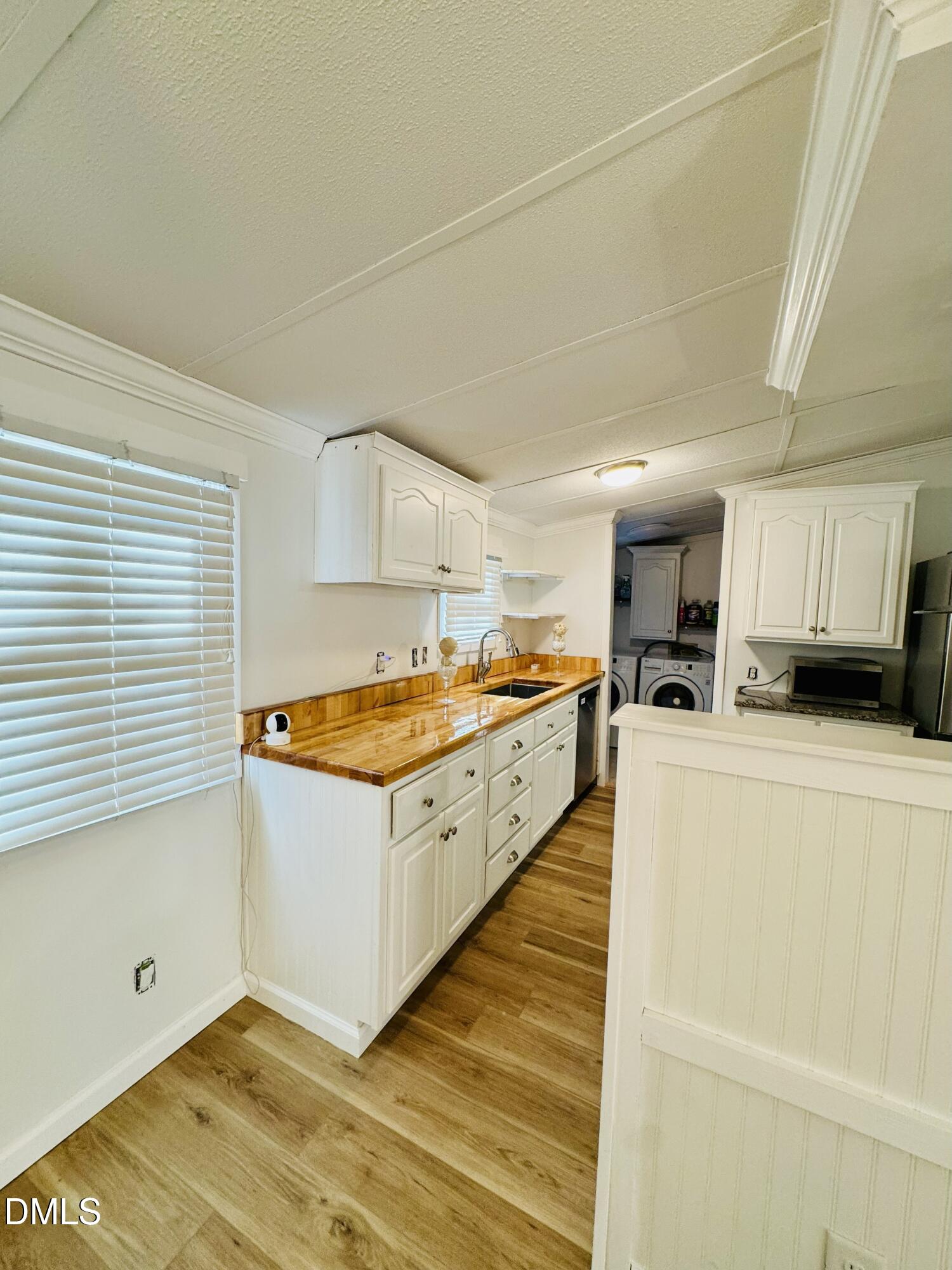 3280 Lakebay Road Vass, NC 28394 - Photo 10 of 41 a kitchen with stainless steel appliances granite countertop a stove a sink and a refrigerator