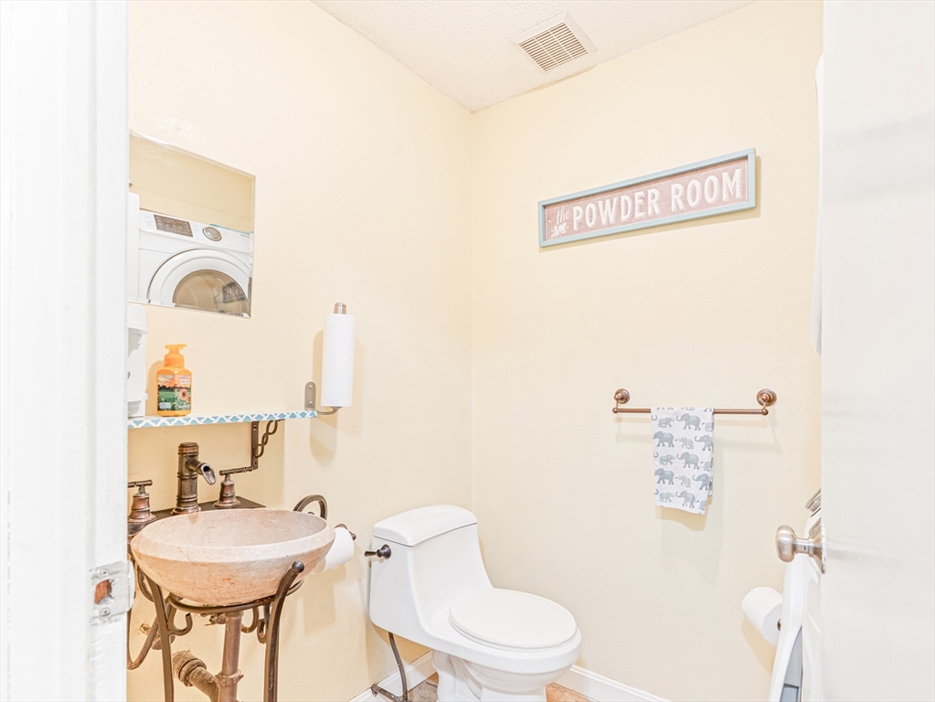 945 Riverside Drive, Unit 2A Methuen, MA 01844 - Photo 16 of 39 a white toilet sitting next to a bathroom sink