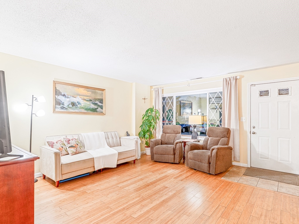 945 Riverside Drive, Unit 2A Methuen, MA 01844 - Photo 2 of 39 a living room with furniture and a large window