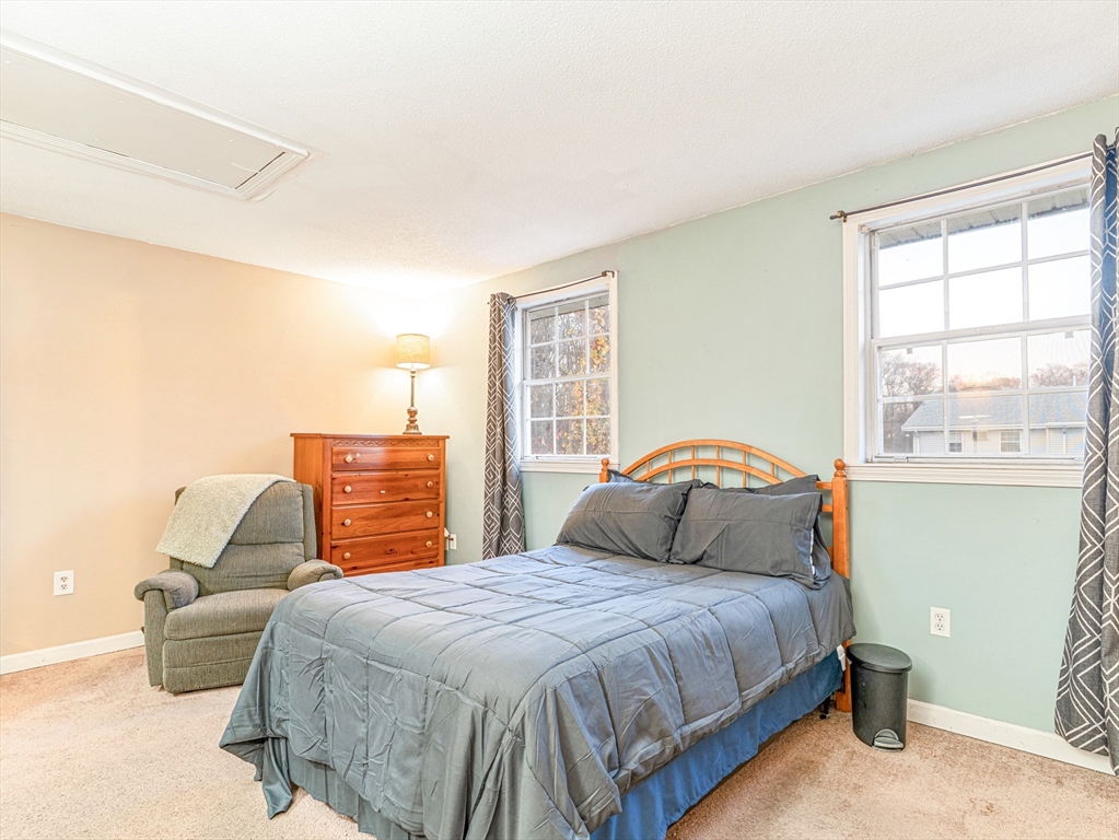 945 Riverside Drive, Unit 2A Methuen, MA 01844 - Photo 21 of 39 a bedroom with a bed and a window