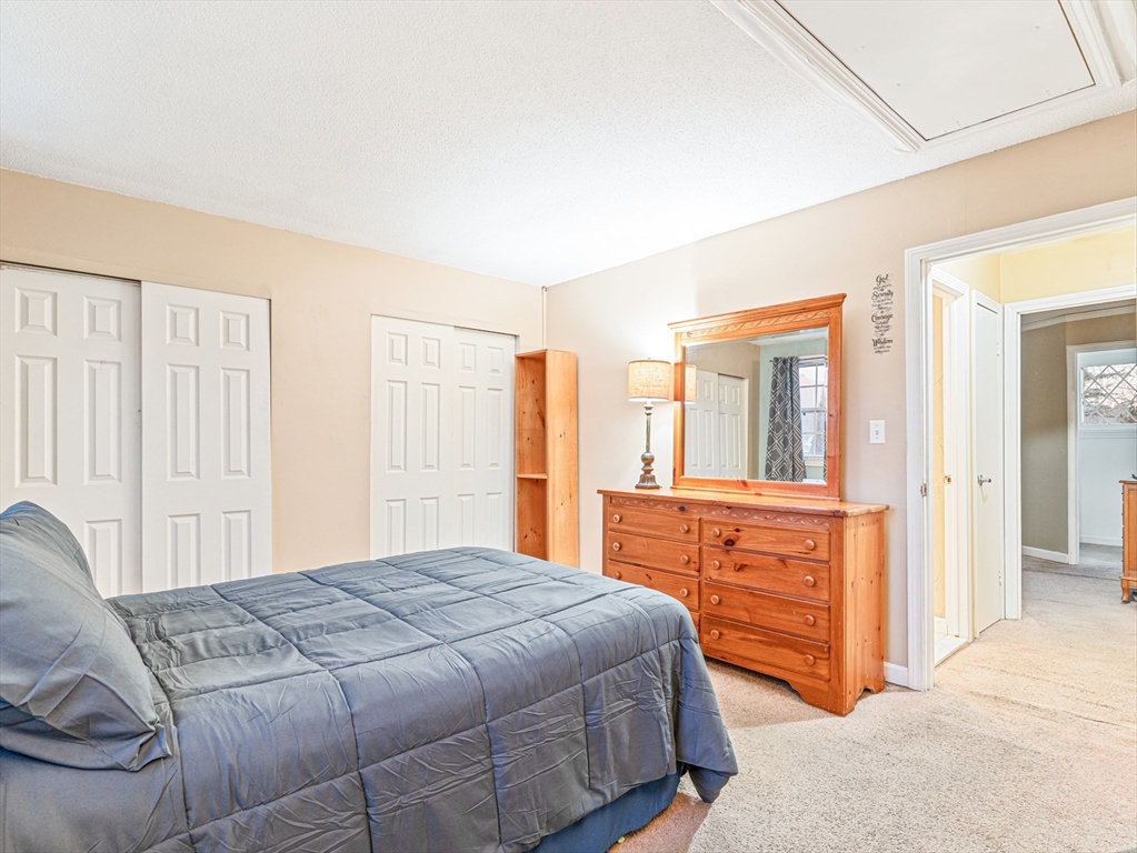 945 Riverside Drive, Unit 2A Methuen, MA 01844 - Photo 23 of 39 a bedroom with a bed and a dresser