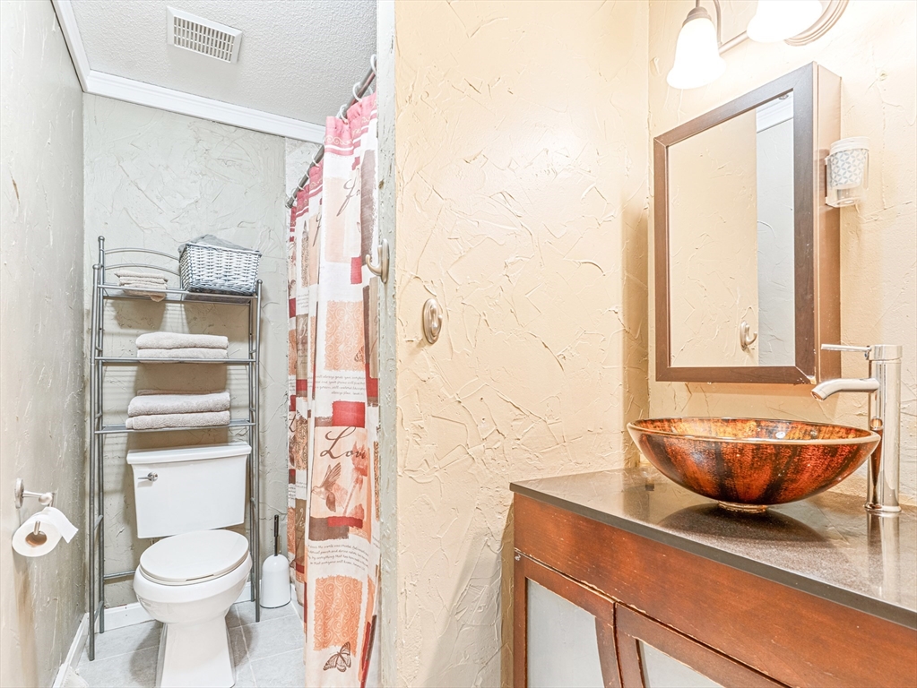 945 Riverside Drive, Unit 2A Methuen, MA 01844 - Photo 24 of 39 a bathroom with a sink toilet vanity and shower
