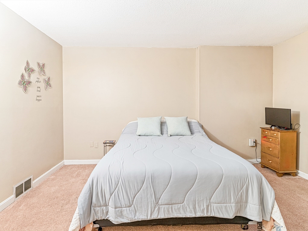 945 Riverside Drive, Unit 2A Methuen, MA 01844 - Photo 29 of 39 a bedroom with a bed and wooden floor