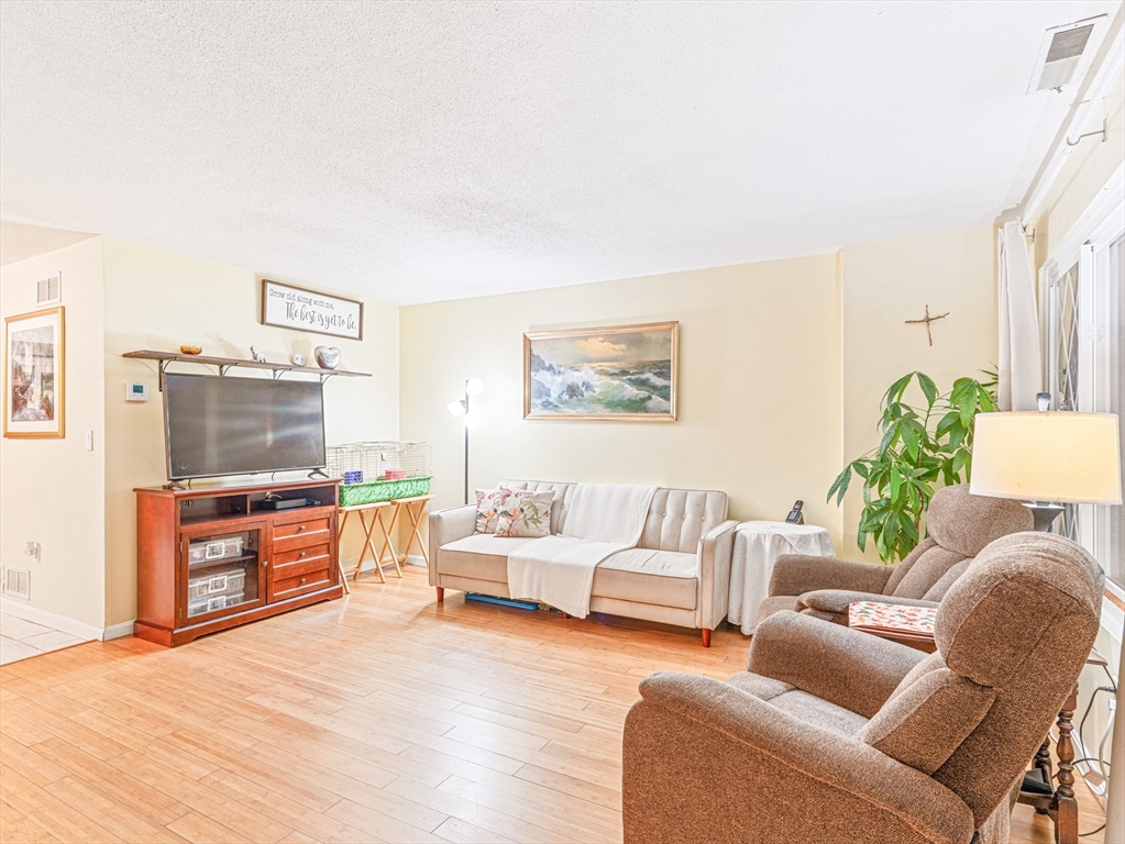 945 Riverside Drive, Unit 2A Methuen, MA 01844 - Photo 3 of 39 a living room with furniture and a flat screen tv