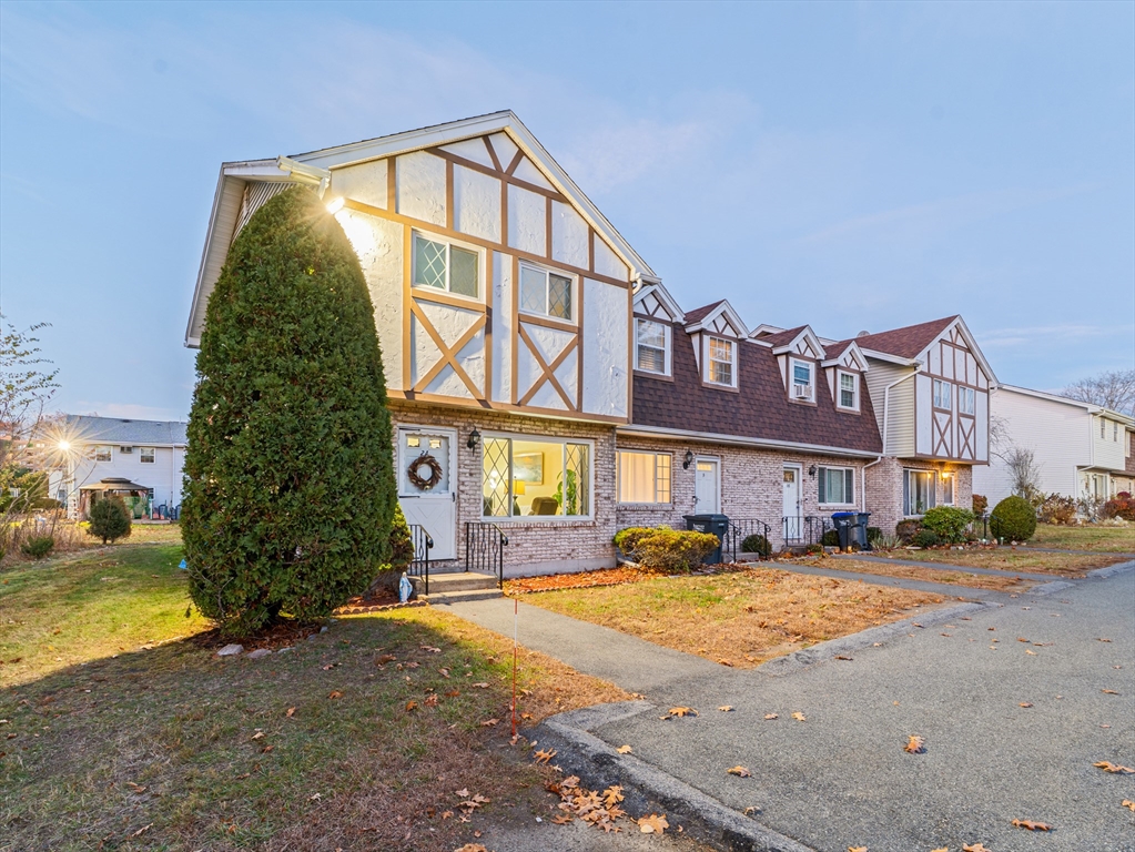 945 Riverside Drive, Unit 2A Methuen, MA 01844 - Photo 31 of 39 a front view of a residential apartment building with a yard