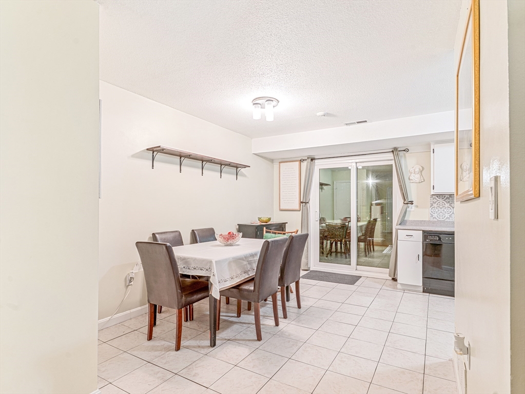 945 Riverside Drive, Unit 2A Methuen, MA 01844 - Photo 9 of 39 a view of a dining room with furniture and a fireplace