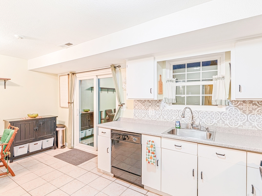 945 Riverside Drive, Unit 2A Methuen, MA 01844 - Photo 10 of 39 a kitchen with granite countertop a sink and a stove next to a window