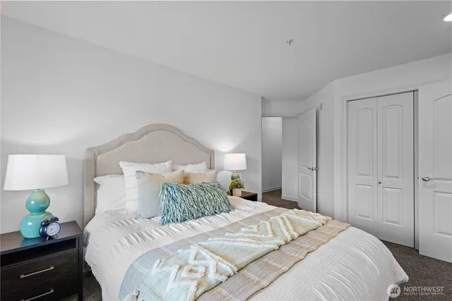 a bedroom with a bed and lamps