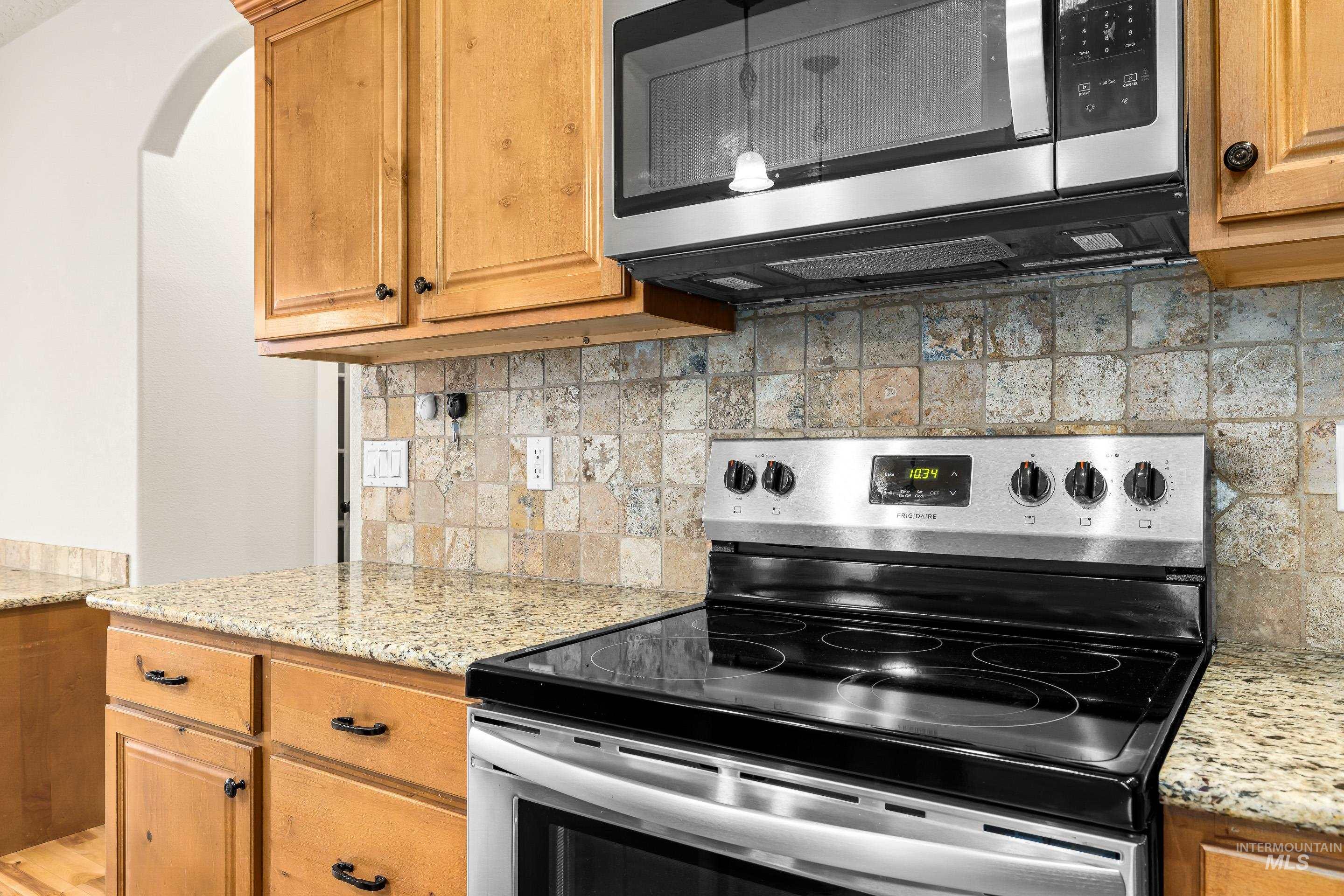 2578 South Groom Way Meridian, ID 83642 - Photo 14 of 39 Kitchen featuring appliances with stainless steel finishes, light stone counters, and decorative backsplash