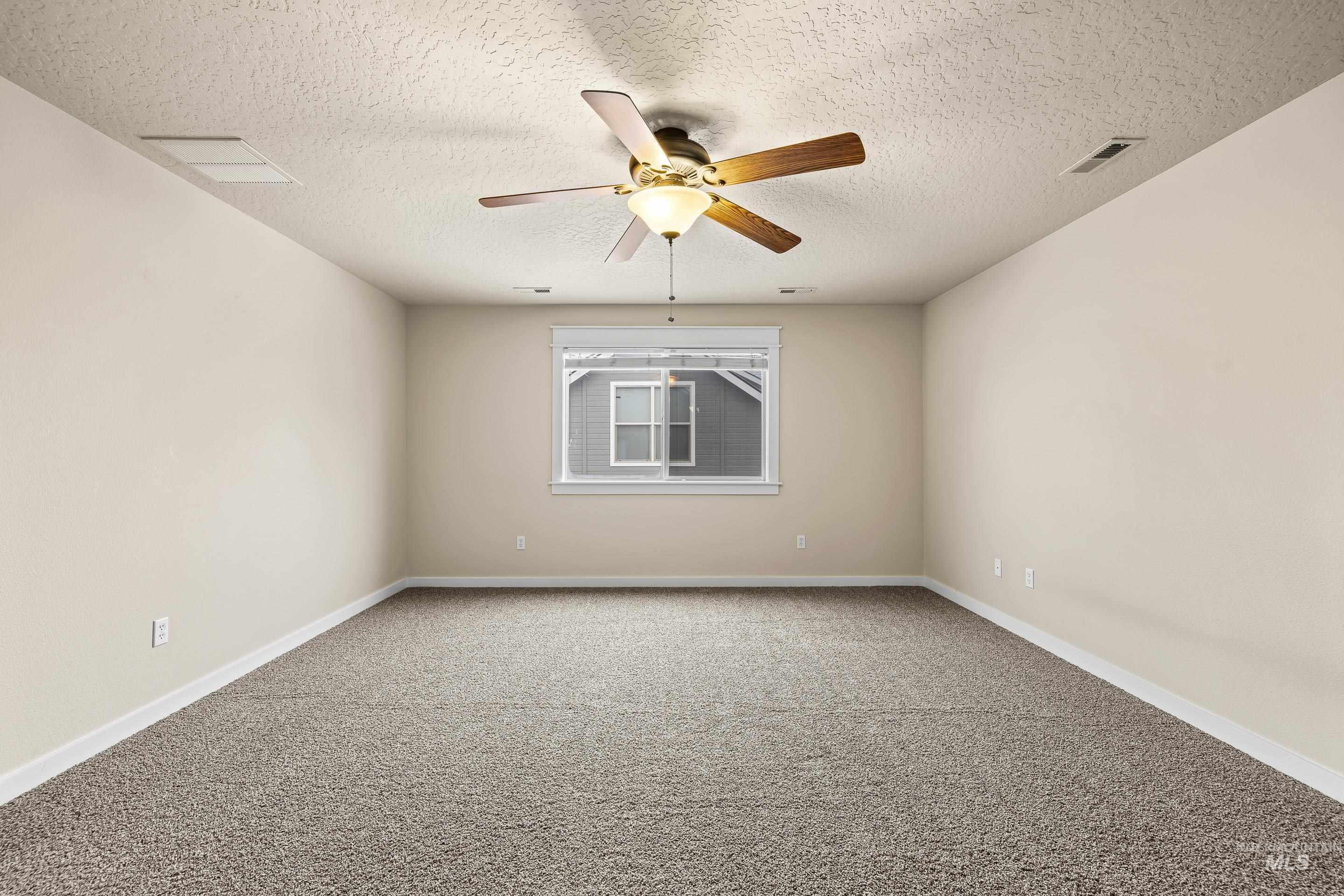 2578 South Groom Way Meridian, ID 83642 - Photo 19 of 39 Carpeted empty room featuring a textured ceiling and ceiling fan