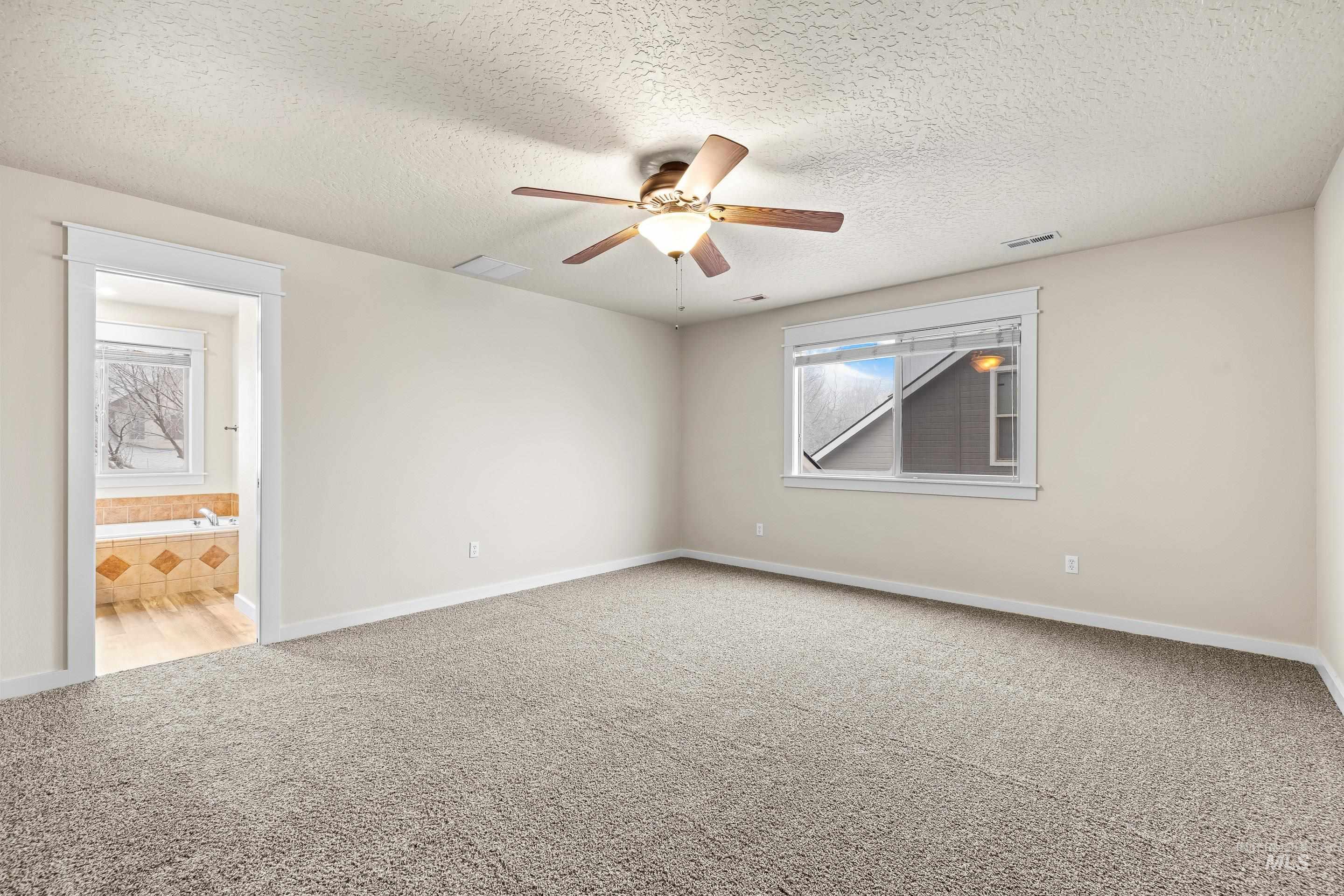 2578 South Groom Way Meridian, ID 83642 - Photo 20 of 39 Spare room featuring light colored carpet, a textured ceiling, and ceiling fan