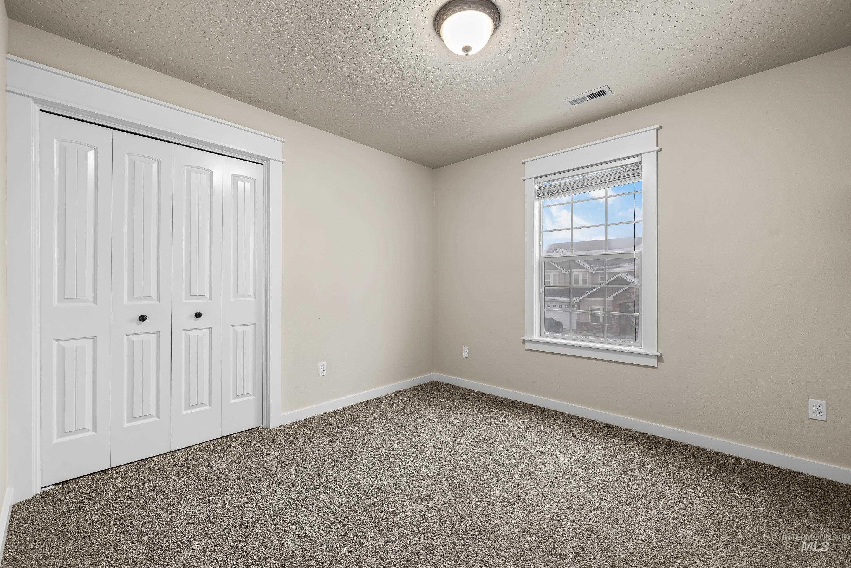 2578 South Groom Way Meridian, ID 83642 - Photo 27 of 39 Unfurnished bedroom featuring a textured ceiling, a closet, and carpet flooring