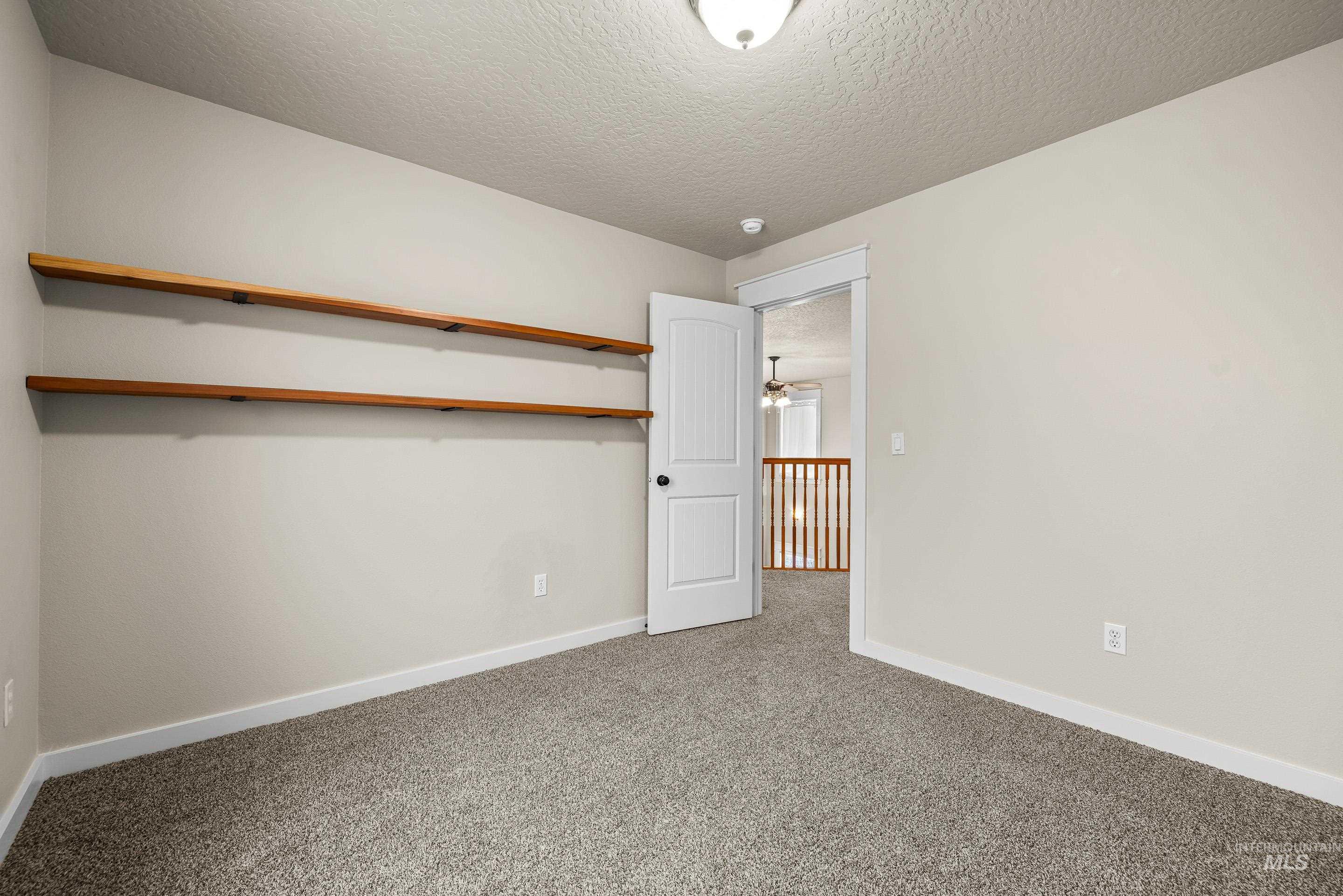 2578 South Groom Way Meridian, ID 83642 - Photo 28 of 39 Carpeted spare room with a textured ceiling and baseboards