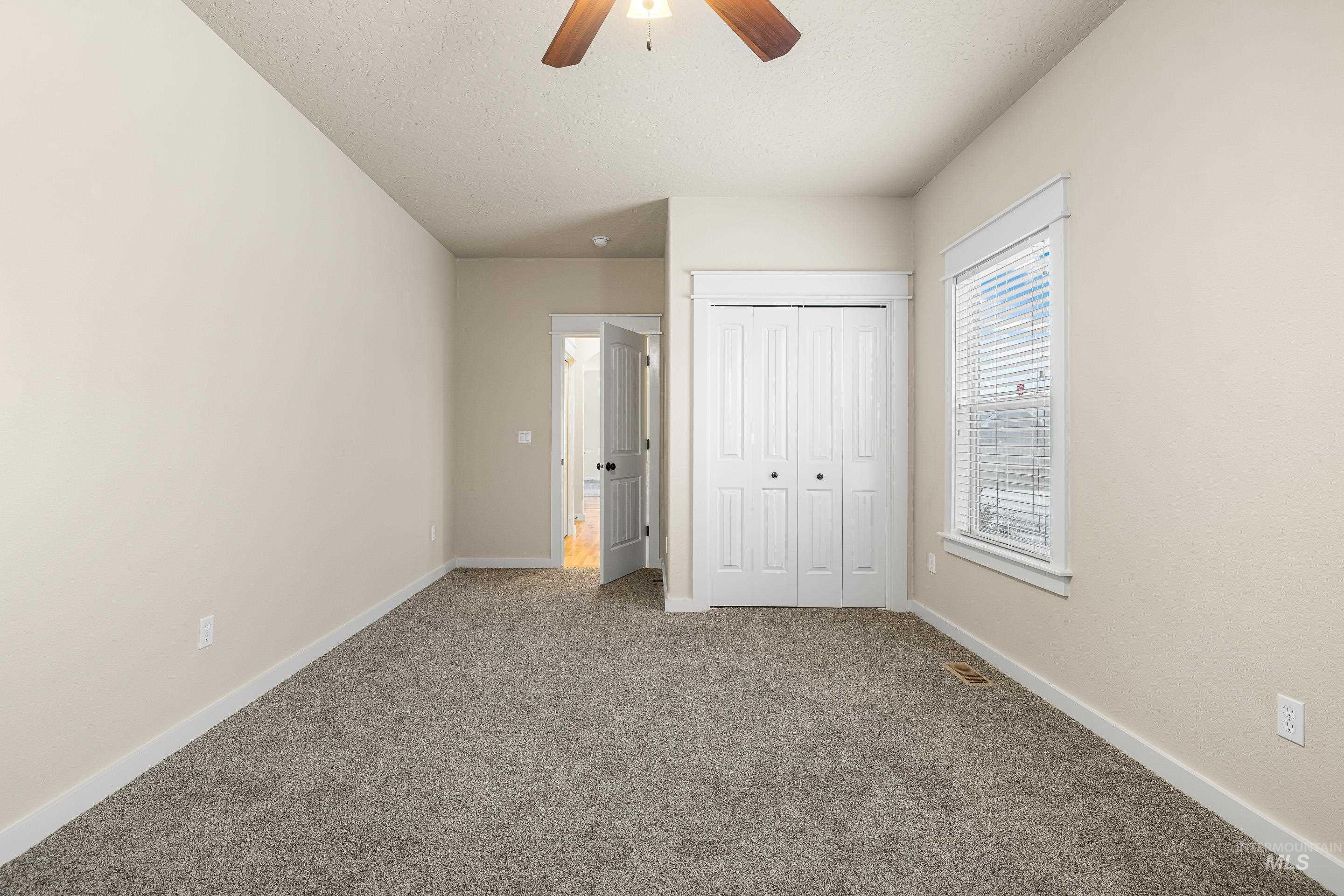 2578 South Groom Way Meridian, ID 83642 - Photo 31 of 39 Unfurnished bedroom with carpet flooring, a closet, ceiling fan, and a textured ceiling