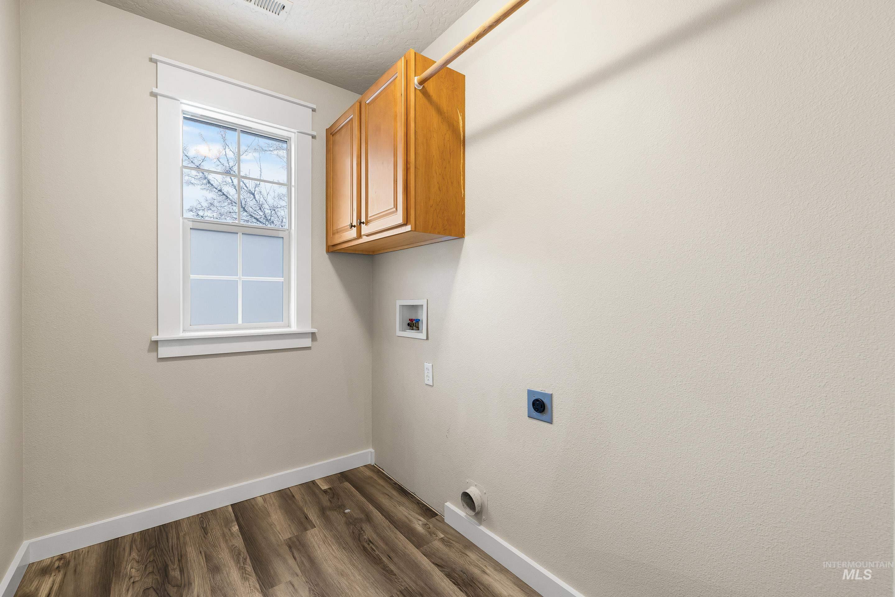 2578 South Groom Way Meridian, ID 83642 - Photo 33 of 39 Laundry room with dark wood-type flooring, cabinet space, hookup for an electric dryer, and washer hookup