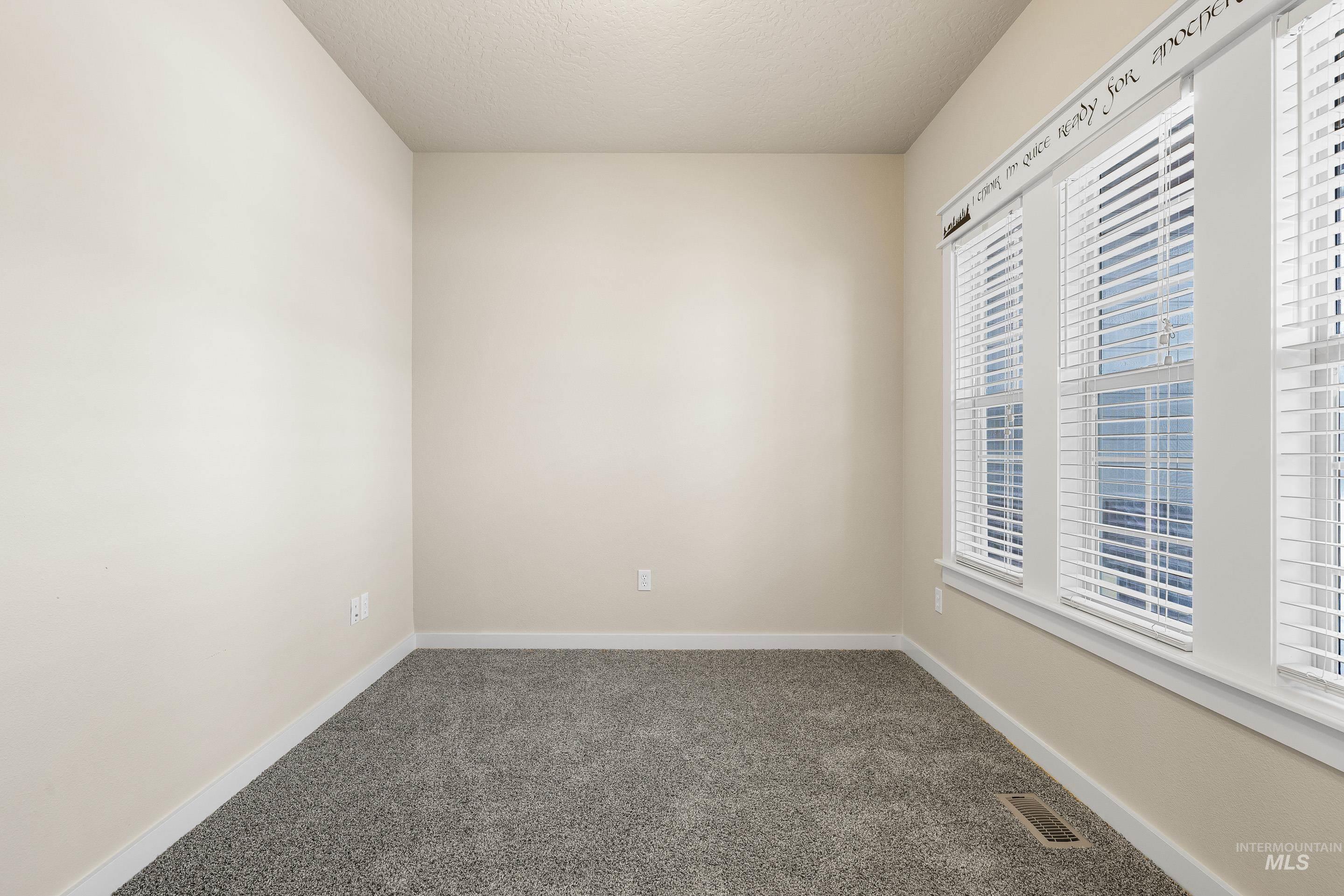 2578 South Groom Way Meridian, ID 83642 - Photo 5 of 39 Carpeted spare room with baseboards and a textured ceiling