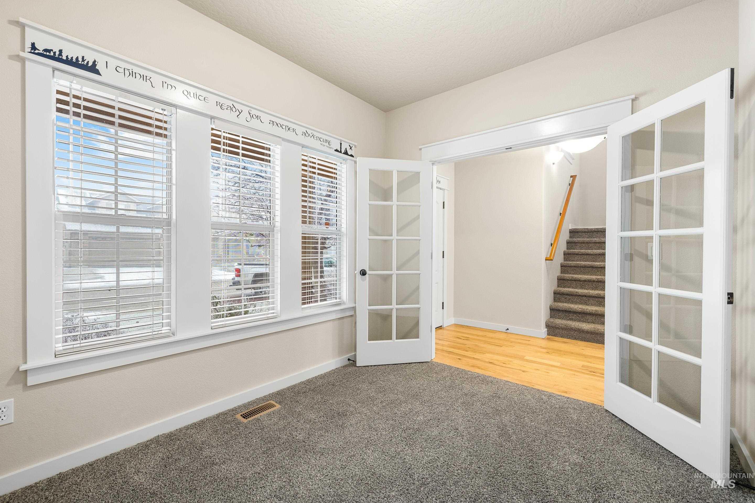 2578 South Groom Way Meridian, ID 83642 - Photo 6 of 39 Empty room featuring stairs, french doors, and light colored carpet