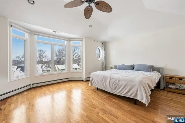 a spacious bedroom with a large bed and a large window