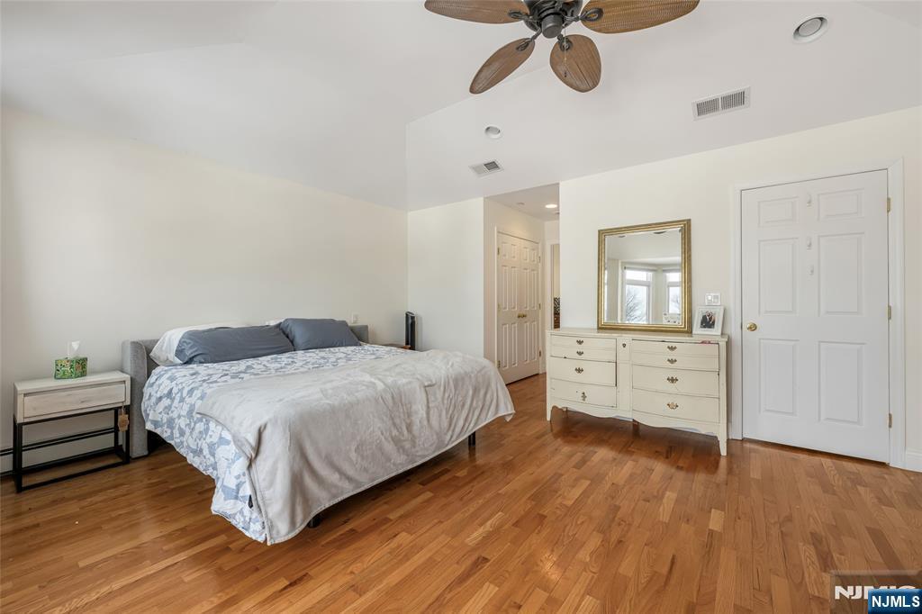 682 Greeley Avenue, Unit A Fairview, NJ 07022 - Photo 15 of 23 a bedroom with a bed and a chandelier