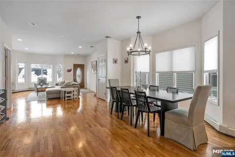a dining room with furniture window and wooden floor