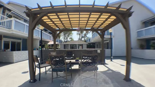 a roof deck with table and chairs