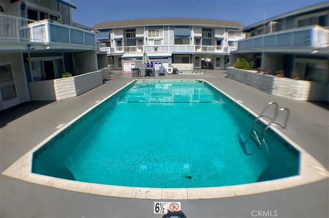 a view of a house with a backyard patio and a swimming pool