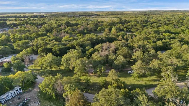 a view of a city with lush green forest