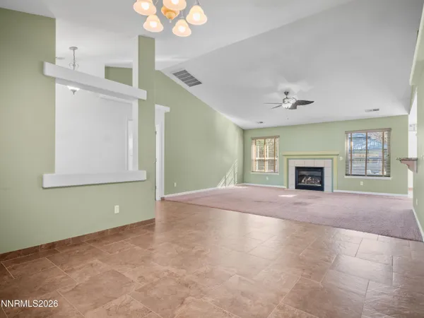 a view of empty room with window and fireplace