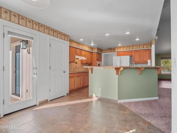 a view of a kitchen with refrigerator and a sink