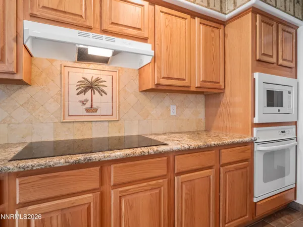 a kitchen with stainless steel appliances granite countertop a refrigerator and cabinets