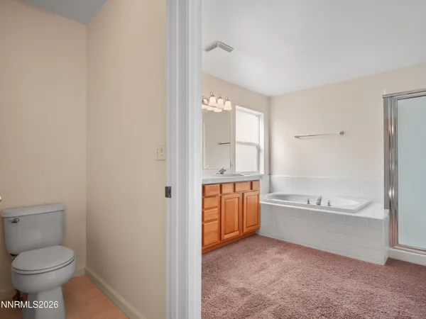 a bathroom with a granite countertop toilet a sink and bathtub